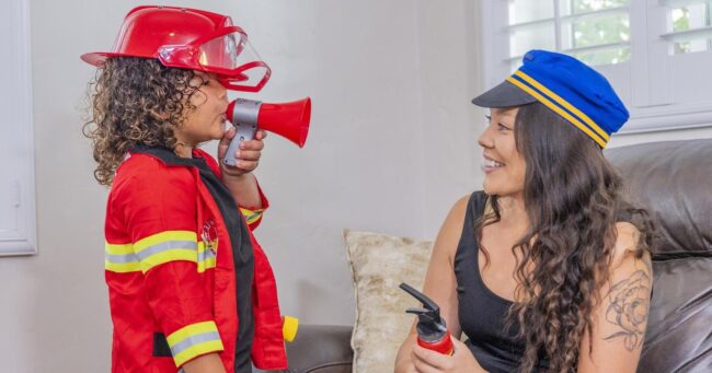 Preschool boy play pretend as firefighter with mom